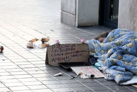 Un mendigo pide limosna en una calle del centro de Valencia.