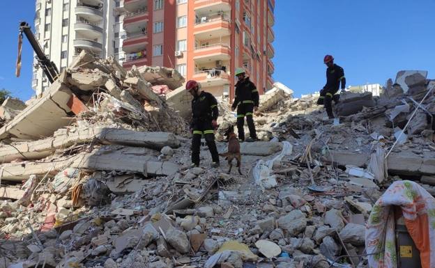 Los bomberos buscan a personas atrapadas entre los escombros en Turquía.