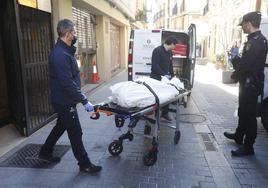 El cadáver del canónigo es sacado del inmueble en el que han sucedido los hechos en Valencia.