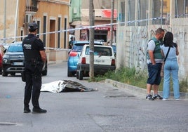 Un policía local junto al cadáver de la víctima.