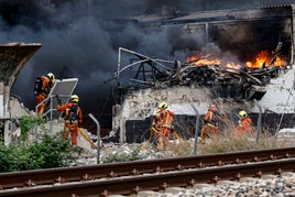 Los bomberos, durante la extinción del incendio que afectó a la fábrica de Cecotec en Sollana.