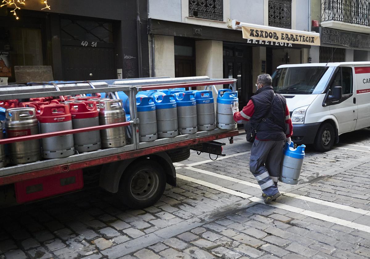 Un trabajador carga una bombona de butano.