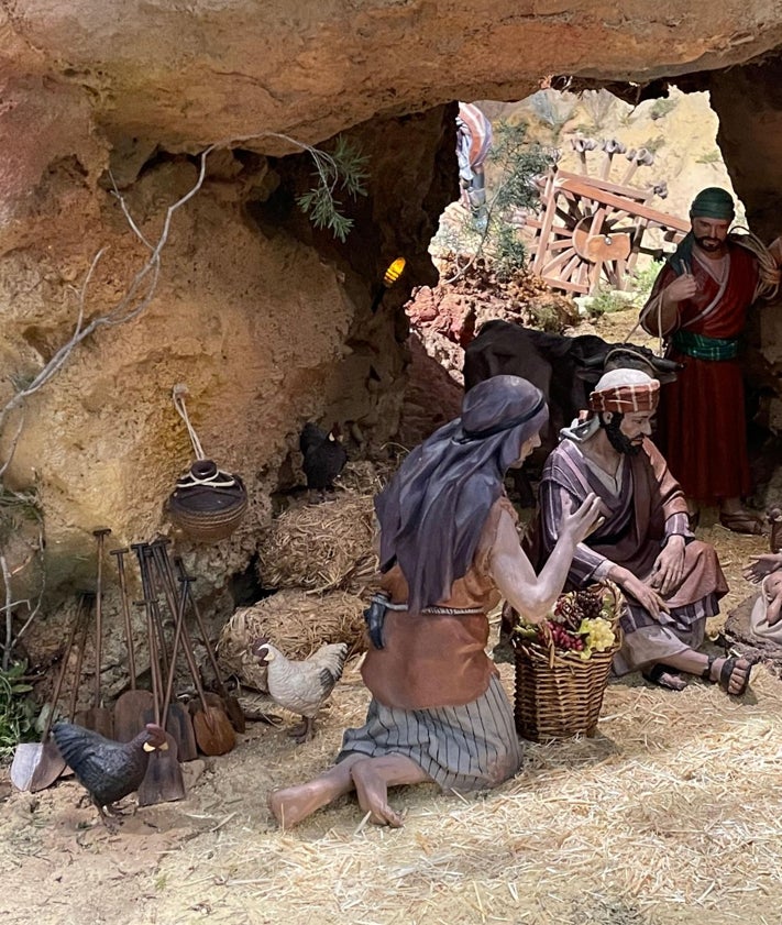 Imagen secundaria 2 - Voluntario de la DANA junto a los Reyes de Oriente, pesebre con la rosa blanca y palas apoyadas en un escenario del belén.