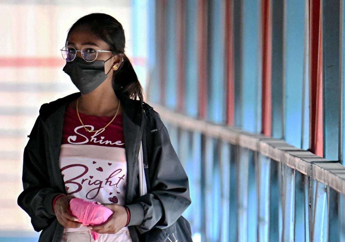 Una mujer con mascarilla en la India.