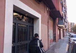 Una joven pasa junto al edificio donde residía la anciana fallecida.