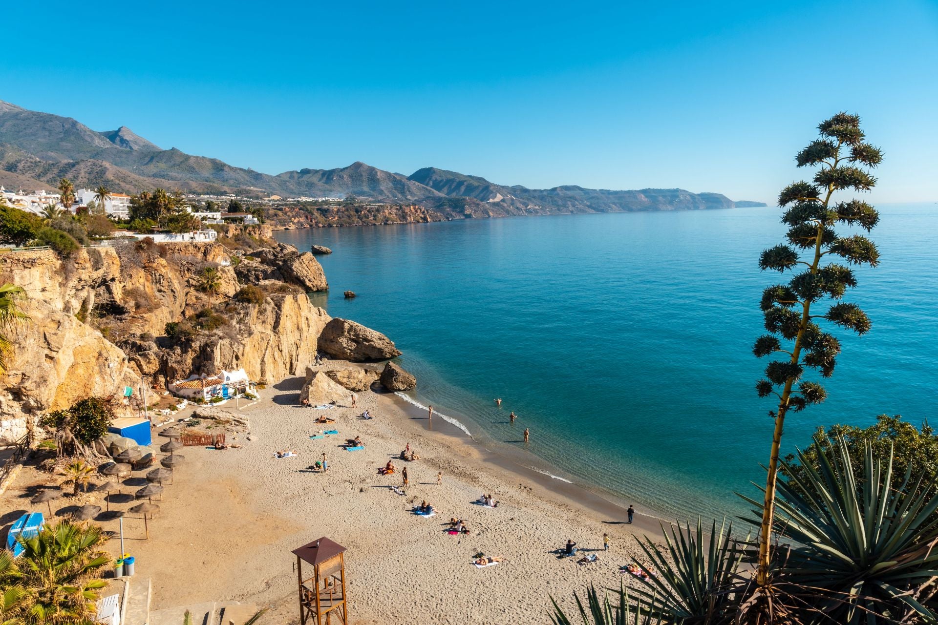 Playa de Calahonda, Málaga, Andalucía (España). Dicen de ella que se trata de la playa «más fotografiada y visitada de Nerja, debido, entre otras cosas a su céntrica situación próxima al Paseo del Balcón de Europa, un mirador con impresionantes vistas al mar Mediterráneo, y colindante con la cala del Chorrillo». Entre sus atractivos destacan «sus antiguas casas o almacenes construidos próximos a las rocas, de paredes blancas y puertas azules, que dotan a esta playa de un encanto particular». También hablan de su «arena oscura y oleaje moderado, es su belleza natural». Por último, indican que «su ubicación la convierte en un lugar ideal para practicar deportes acuáticos como el snorkel o el buceo». «En sus aguas transparentes se pueden ver peces de colores, pulpos y estrellas de mar».