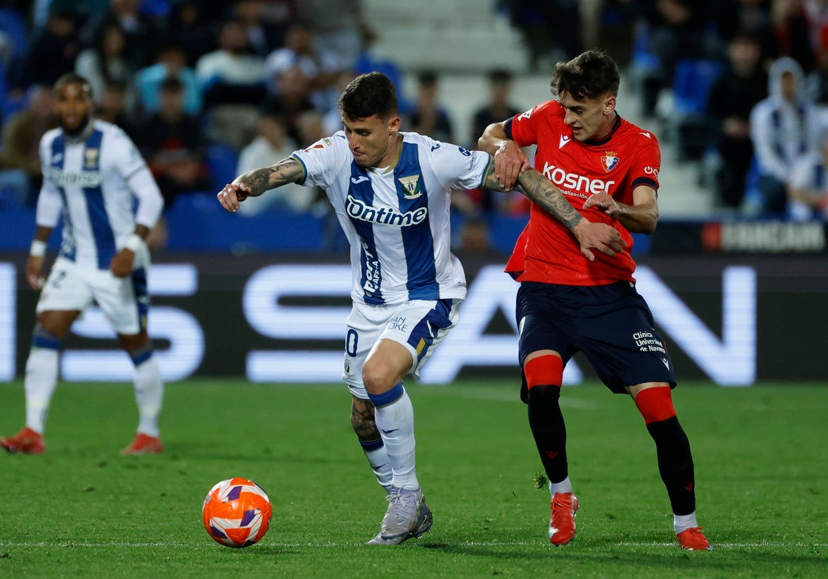 Dani Raba disputa un balón junto a Aimar Oroz.