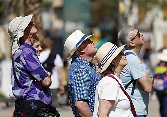 Turistas observan un monumento en el centro de Valencia.