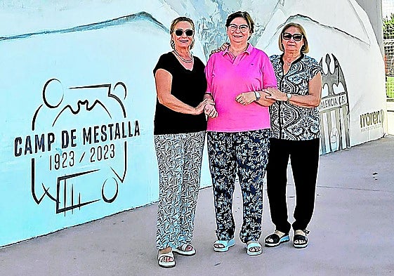 Pilar, Paz y Elo posan en el mural de su tío que hay en el complejo polideportivo de Sueca, que tiene también el campo Antonio Puchades.