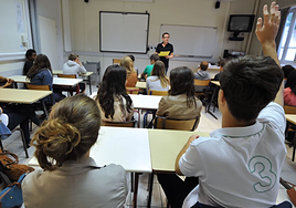 Un profesor imparte una clase en un colegio.