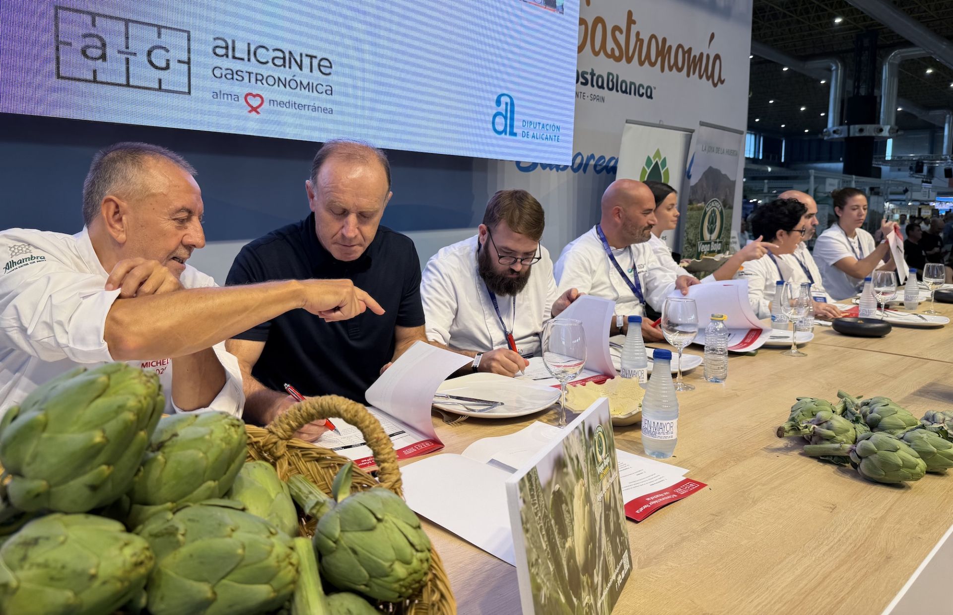 Imagen principal - El jurado, el plato ganador y los chef cocinando durante el concurso. 