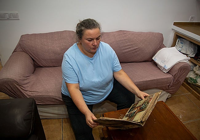 Mari Carmen revisa un álbum familiar, en una imagen facilitada por la oenegé.