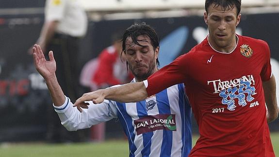 Un jugador del Nastic lucha la pelota.