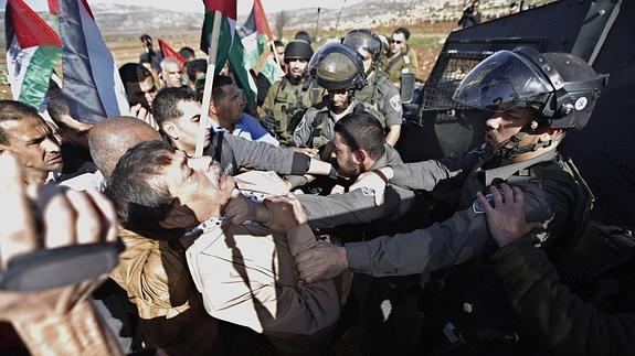 Ziad Abu Ein, agarrado por un policía israelí.