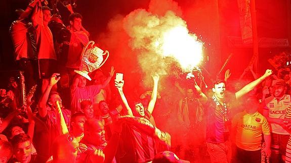 Varios aficionados celebran en Barcelona la victoria azulgrana.