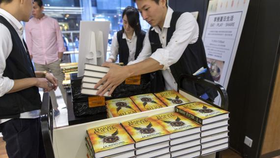 Dependientes de una librería de Hong-Kong colocan el nuevo libro de Harry Potter.