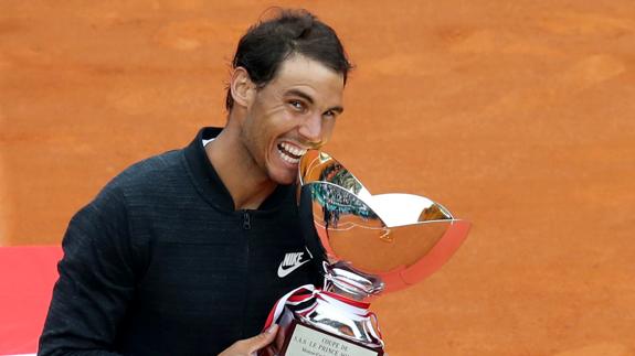 Nadal celebra la victoria mordiendo el trofeo. 