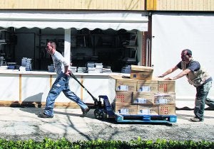 Dos trabajadores transportan, ayer, los libros en Viveros. ::                             IRENE MARSILLA