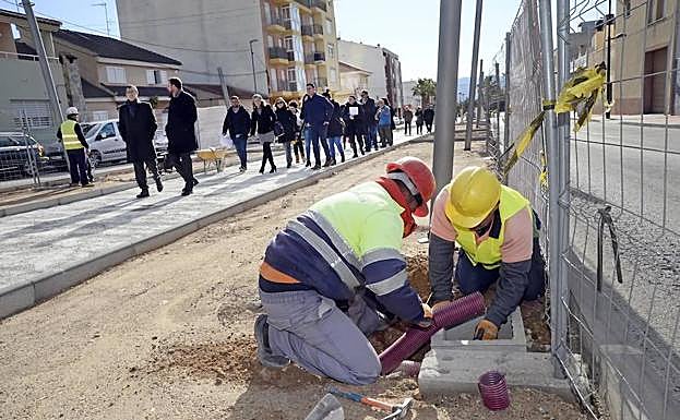 Dos operarios trabajan en las obras de ampliación de la Avenida de la Constitución, en Sangonera la Seca.