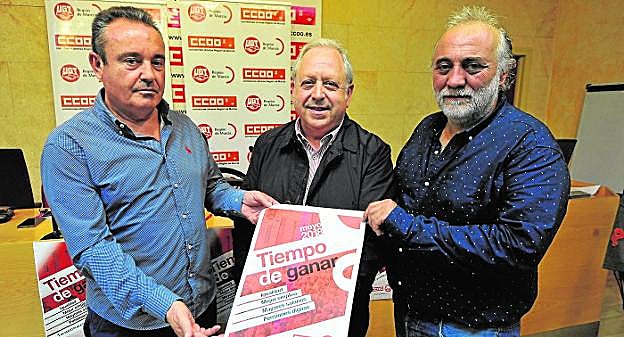 Santiago Navarro (CC OO), Antonio Jiménez (UGT) y José Sáez (USO) muestran el cartel de la convocatoria del 1º de Mayo.