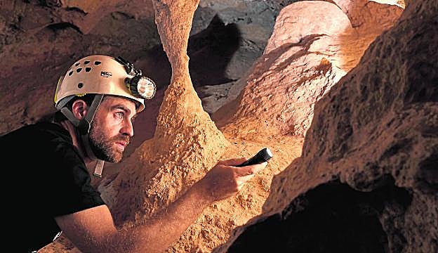 Ignacio Martín Lerma observa con detenimiento las paredes de la galería que nace al fondo de la cavidad superior. 