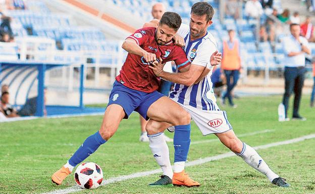 Peke pugna con un jugador del Recreativo.