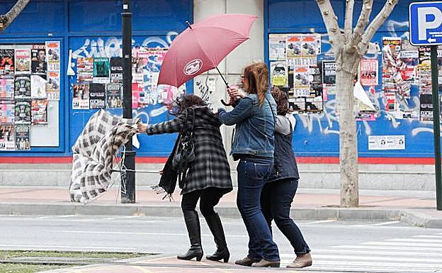 Tres mujeres intentan combatir el viento, en una fotografía de archivo.