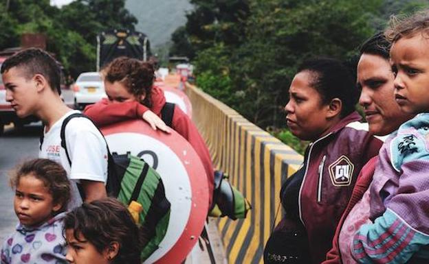 Carelbis Becerra (dch) y Carolinas Rojas (centro) junto a todos sus hijos. Son del estado de Trujillo, Venezuela. Comenzaron su viaje hace tres días y aún les queda una semana para llega a Bogotá caminando.