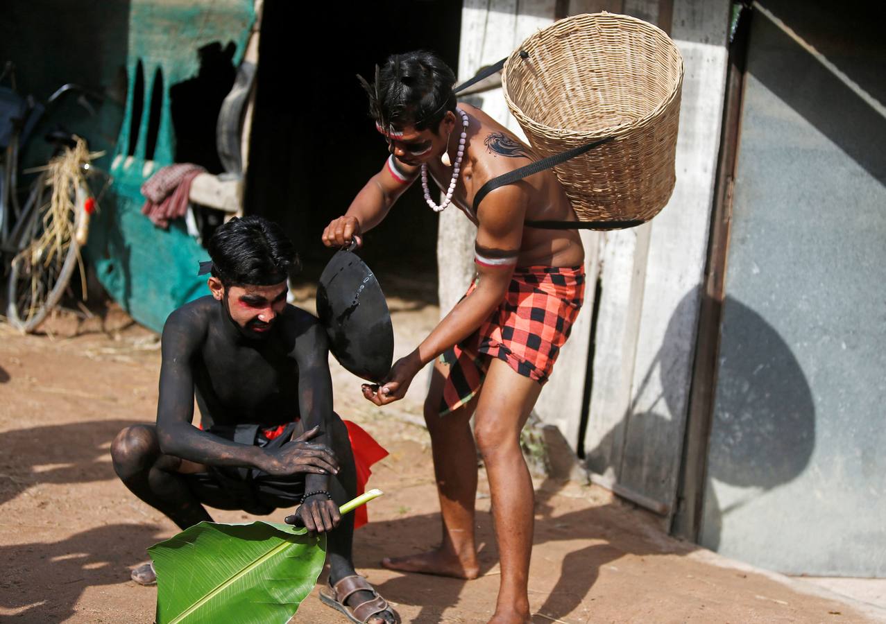 Varias personas participan en la ceremonia que honra la memoria de los espíritus del hogar de la aldea Pring Ka-Ek, este viernes en Nom Pen (Camboya). Los residentes buscan prevenir enfermedades y potenciar las cosechas a través de estos rituales milenarios.