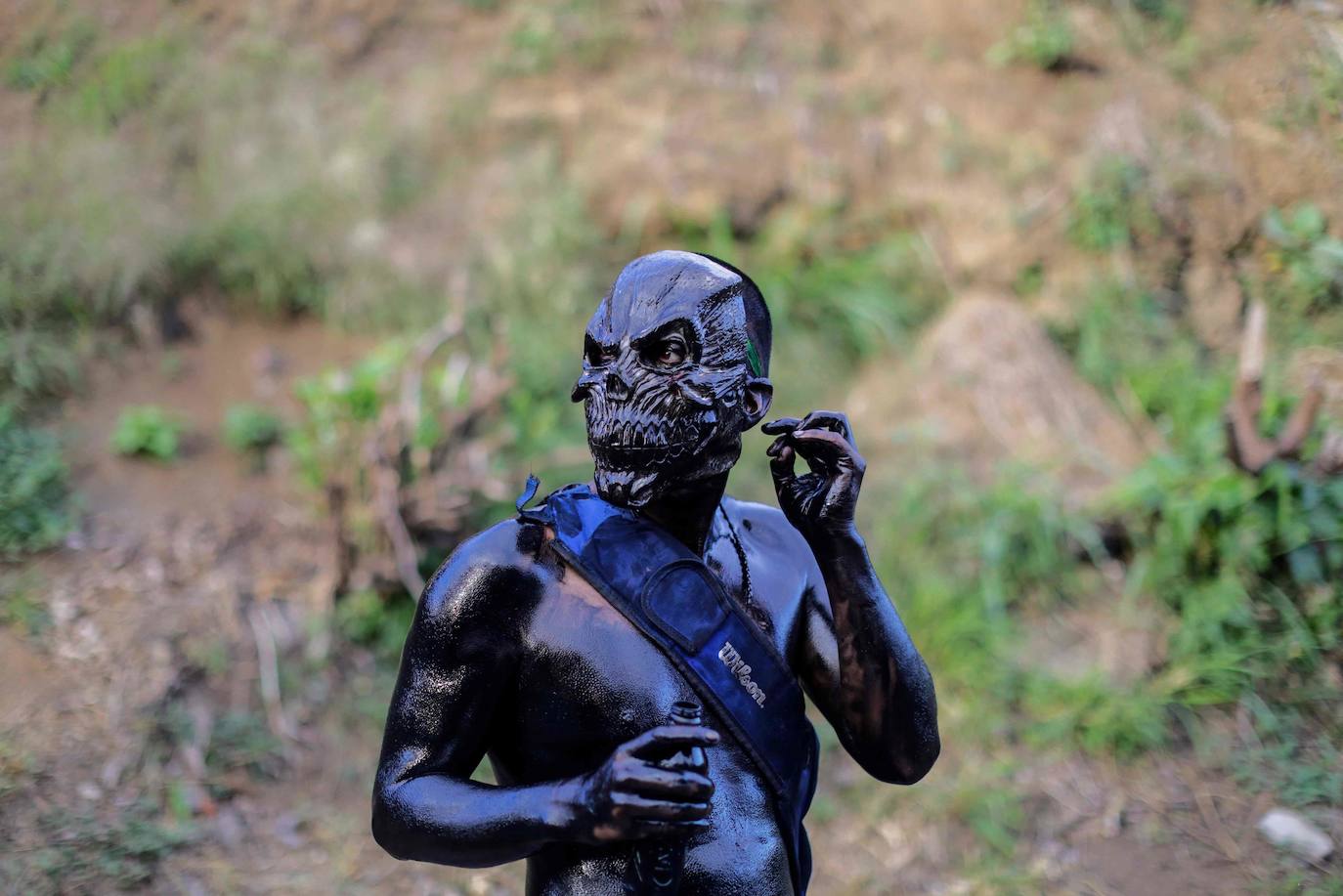 Varias personas llevan el cuerpo cubierto con aceite para cumplir con la tradición de «Los Diablitos Negros» durante una procesión en la que fieles católicos transportan la imagen de Santo Domingo de Guzmán, en Managua (Nicaragua). Como es tradición, la música pone el tono festivo y los creyentes bailan a la vez que avanzan hacia el norte de Managua, alrededor de la imagen, que es zangoloteada por los cargadores, como símbolo de alegría.
