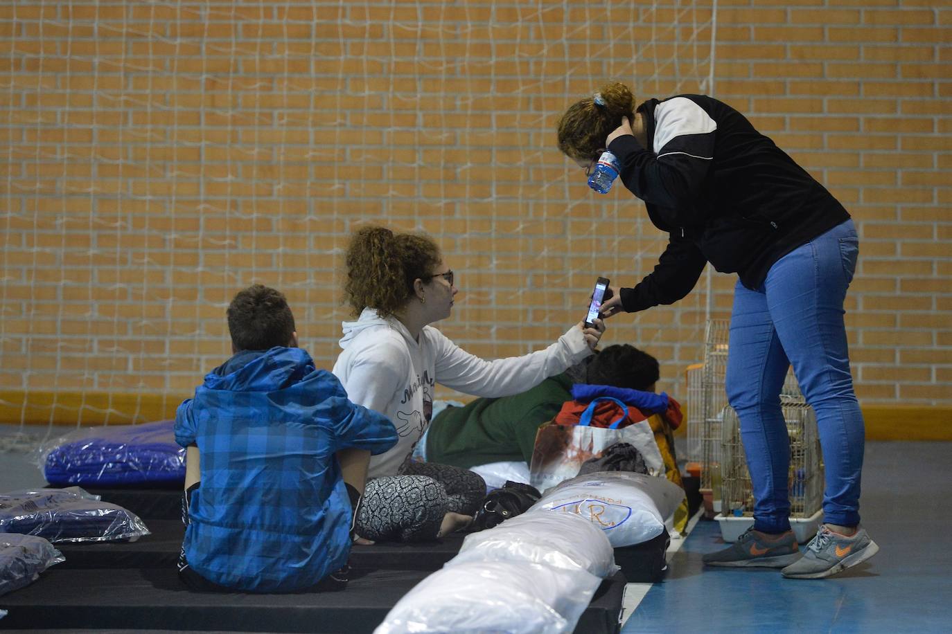 Una familia acude a un pabellón instalado para auxiliar a los afectados.