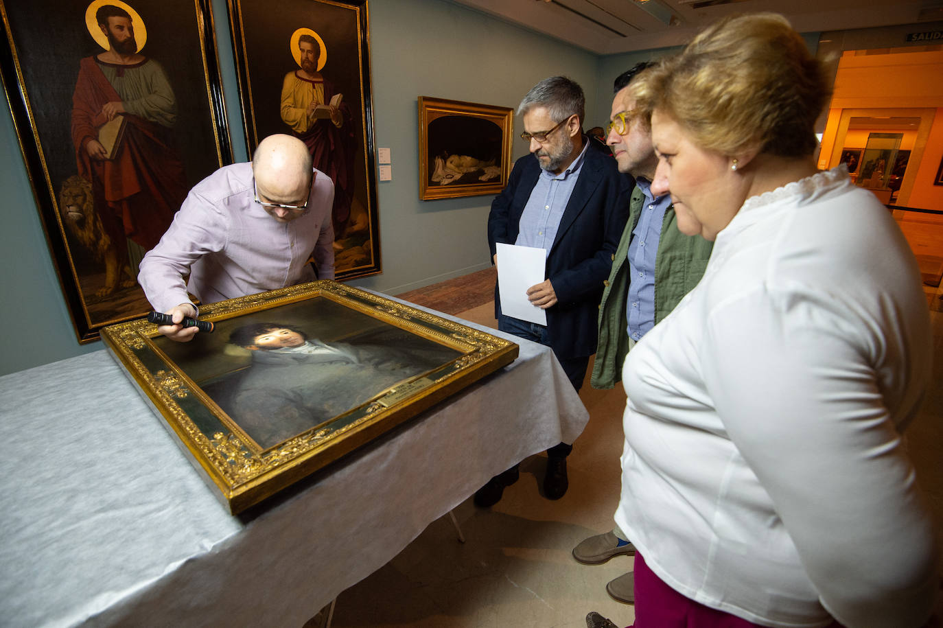 Dos técnicos cuelgan el retrato de Isidoro Máiquez, esta mañana en el Mubam.