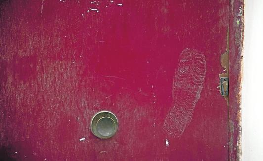Huella de un zapato, en una puerta de la calle San Vicente, ayer.