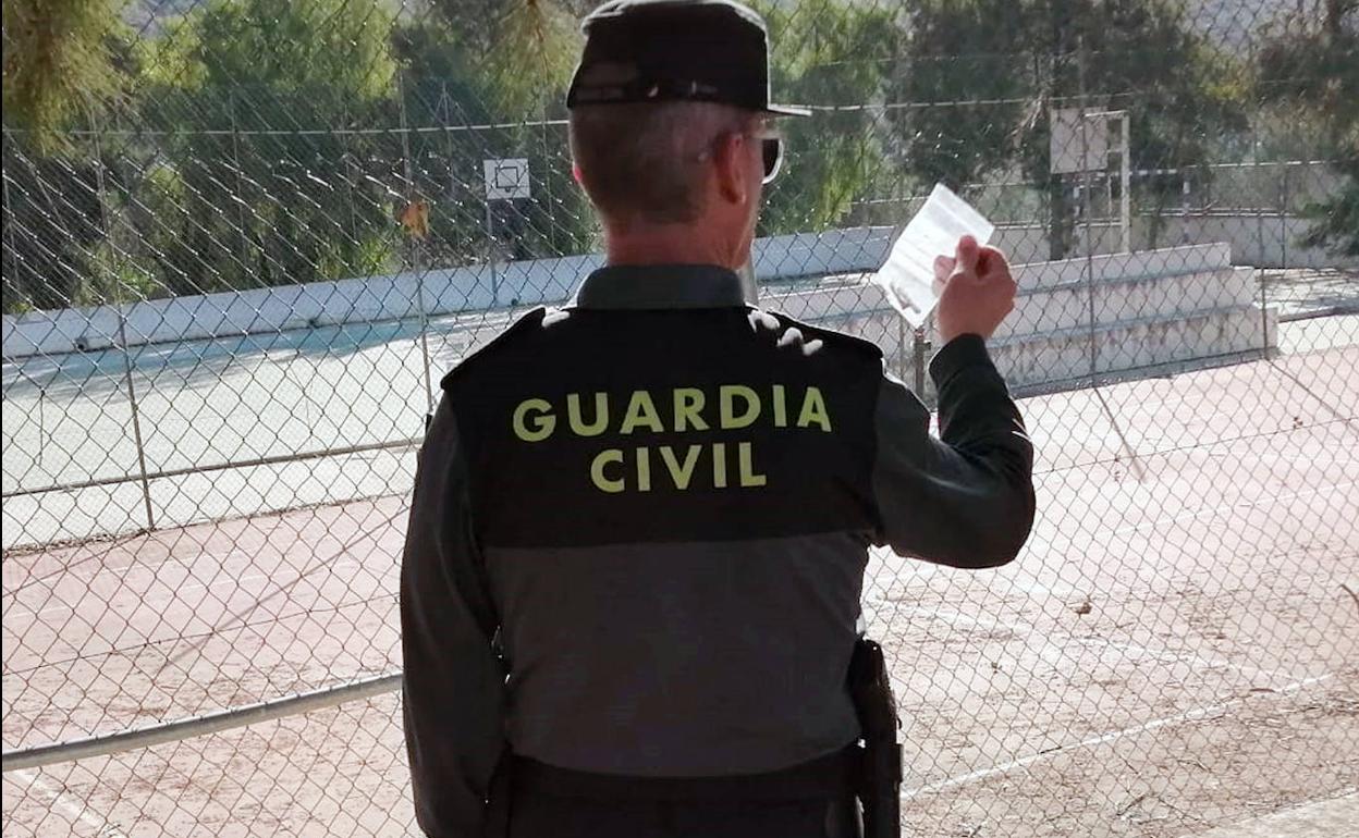 Un agente de la Guardia Civil con parte de la droga incautada.