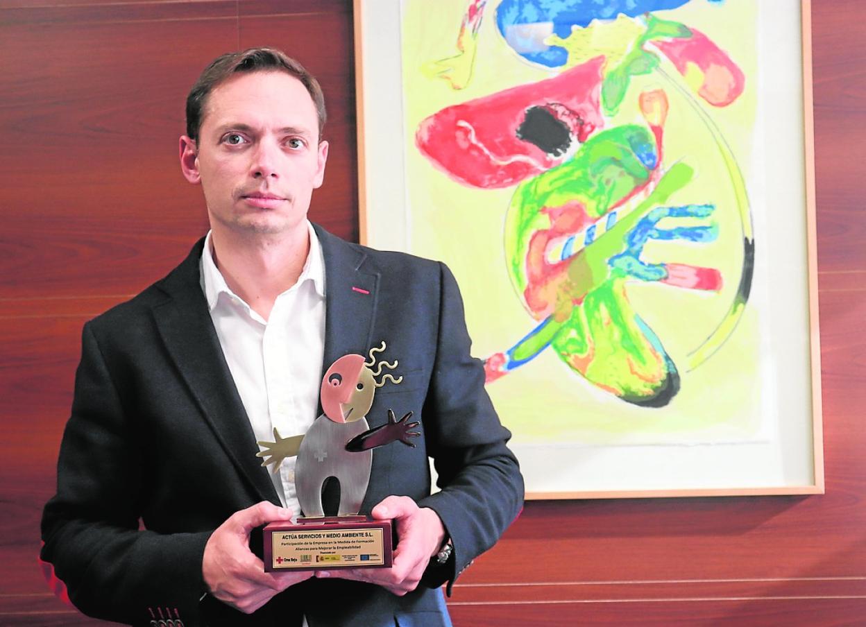 El director corporativo de Actúa SM, Javier Lisón, porta el premio otorgado por Cruz Roja.