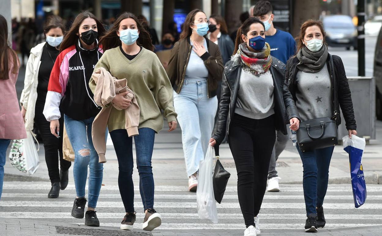 Transeúntes pasean por Murcia con mascarilla. 