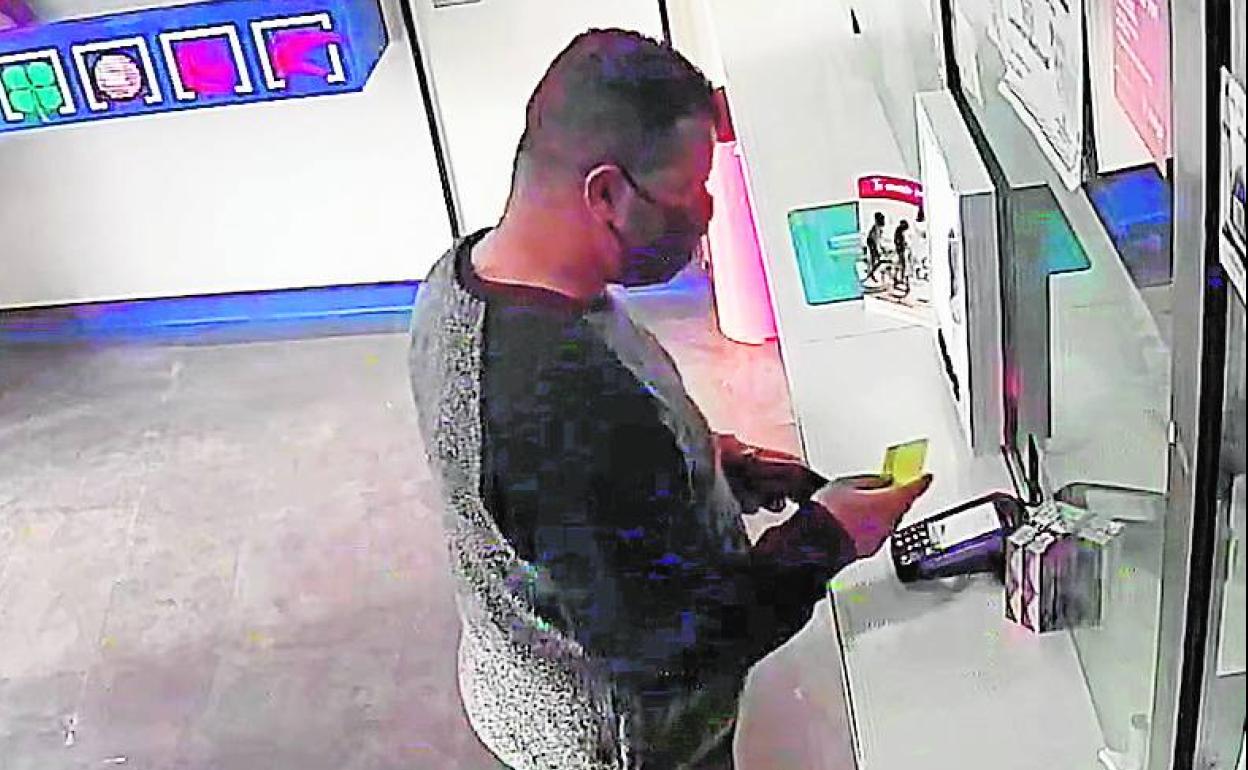 El supuesto autor de los hechos, efectuando un pago con la tarjeta.