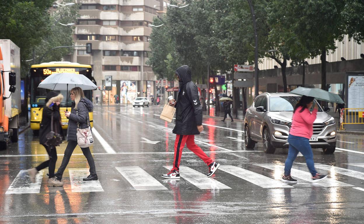 Varias personas pasean por Murcia en un día lluvioso, en una imagen de archivo.