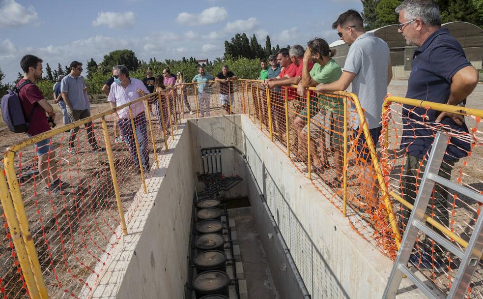 Control de cultivos. Joaquín Navarro, a la izquierda, explica el funcionamiento de la fertirrigación controlada con lisímetros, junto al tanque de drenaje, en el Cifea de Torre Pacheco.