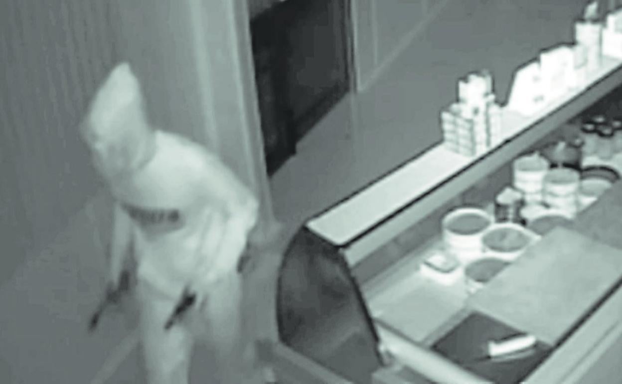 Una cámara graba a un miembro de la banda en el robo a un local.