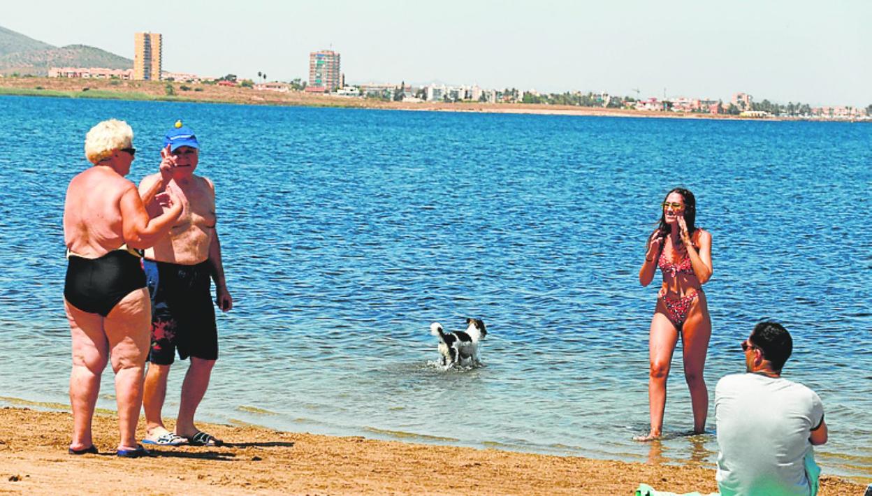 Una bañista con su perro, en la playa de Los Alemanes. 