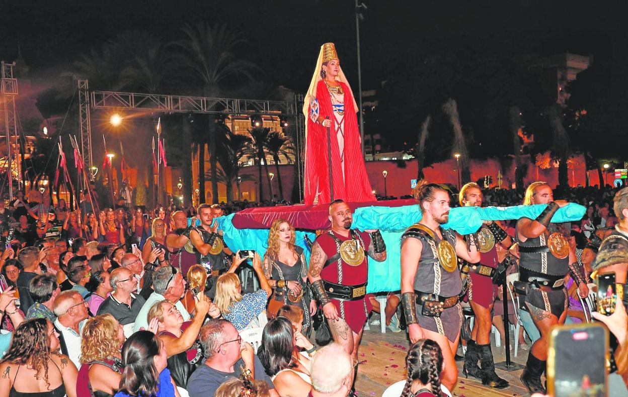 La princesa íbera Himilce, sobre un trono, llega al lugar de la representación de las bodas, repleto de público. 