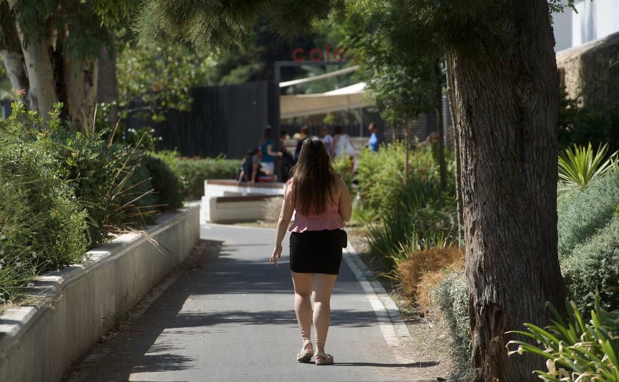 Una mujer camina por la mota del río donde tres mujeres han denunciado que sufrieron abusos. 