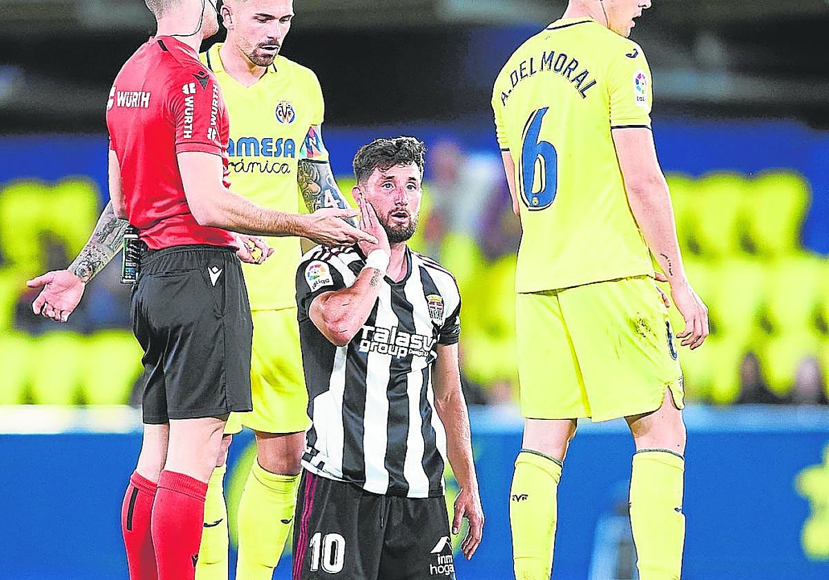 Borja Valle, de rodillas, se queja de una falta de Dela anoche en el estadio de La Cerámica.