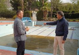El edil Juan Miguel Bayonas y Fulgencio Gil observan el estado de las viejas piscinas de La Torrecilla.