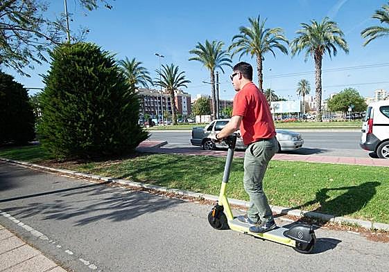 Un usuario circula con un patinete de alquiler en Murcia.