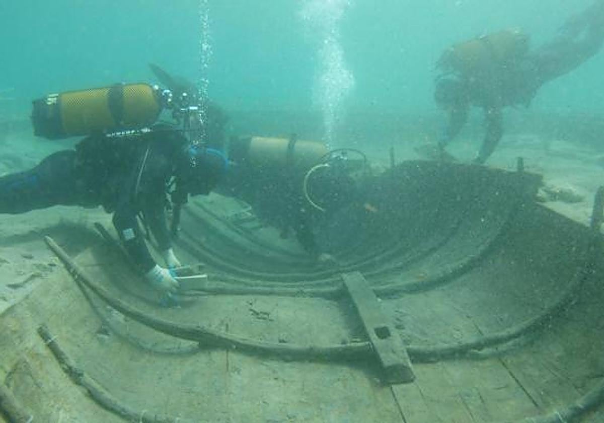 Buzos junto al casco de la nave fenicia de la playa de La Isla, en una imagen de archivo.