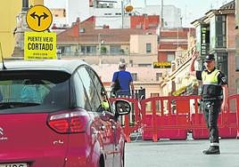 Un coche frente al cartel que avisa del cierre al tráfico del Puente Viejo.