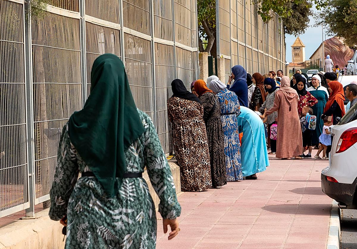 Varias madres de origen extranjero esperan la salida de sus hijos de un colegio de Cartagena en una imagen de archivo.