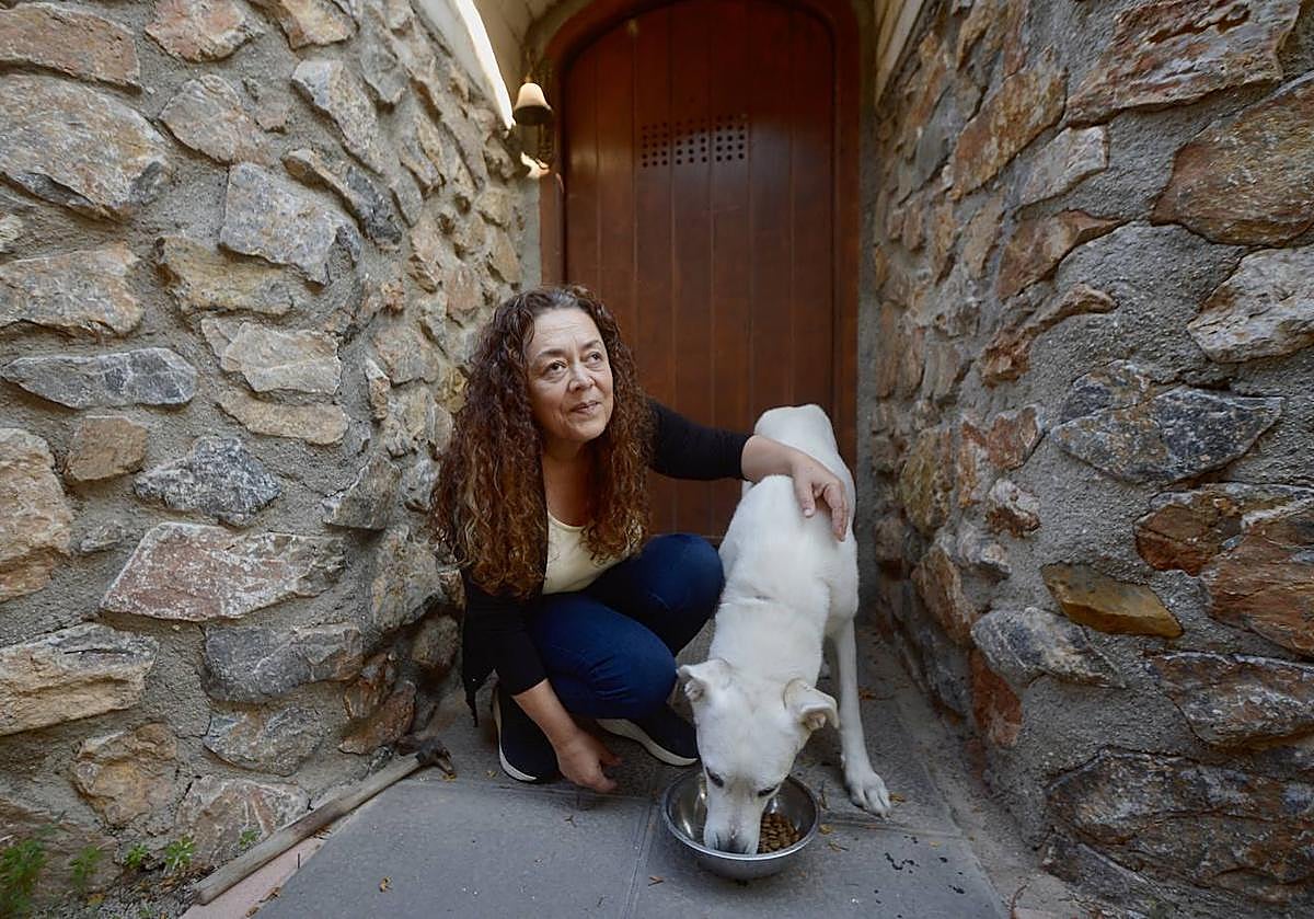 María Jesús Cascales da de comer a su perro en su casa ubicada en La Matanza, en Fortuna.
